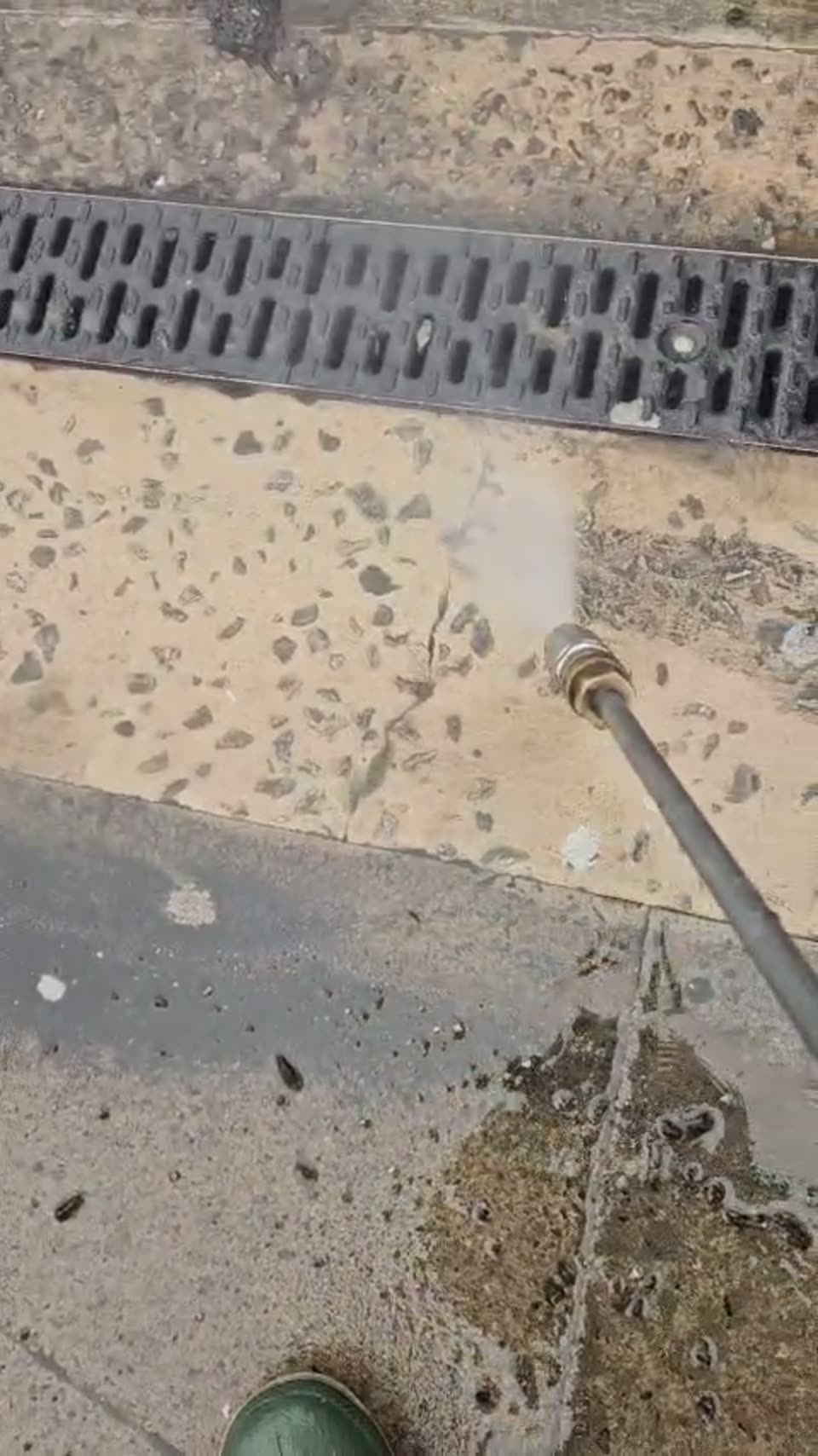 Patio and drainage channel being cleaned