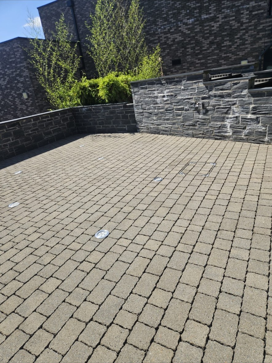 Large block paved commercial courtyard cleaned back to an even finish